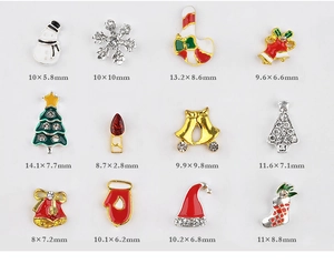 Macro view of 12 assorted Christmas nail art charms with snowflake and snowman designs