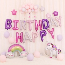 Close-up of pastel unicorn and happy birthday foil balloons for party wall decor