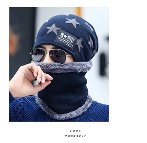 Detail of navy knit beanie and neck warmer with star patterns and plush lining