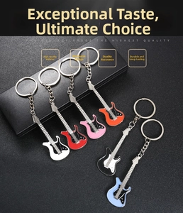 Detailed close-up of guitar-shaped keychains in various colors on a black textured background