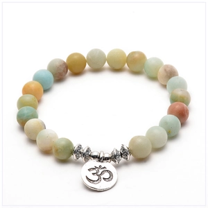 Detail of 8mm amazonite yoga bracelet featuring natural stones and Om charm