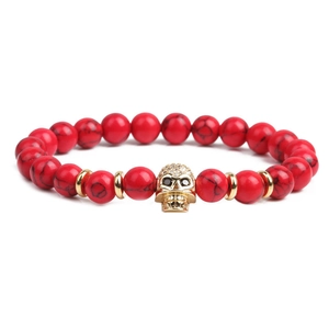 8mm red bead bracelet set featuring gold skull with micro-pave cubic zirconia on white background