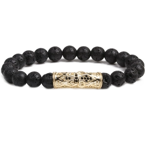 Macro detail of men's black volcanic stone beads with gold engraved metal tube