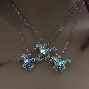 Luminous horse pendant necklaces glowing in blue and green on a neck model