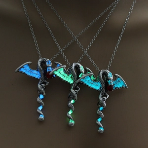 Detailed view of luminous dragon pendants glowing in vibrant blue and green colors
