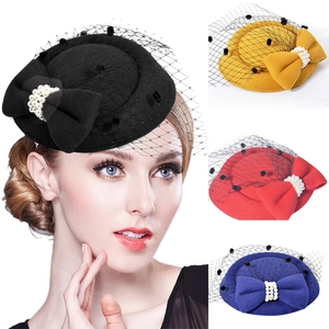Detail of vintage fascinator hat with elegant mesh veil and bow accent in multiple colors