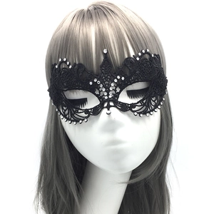 Detailed view of black lace masquerade mask with sparkling rhinestones and intricate embroidery