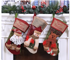 Detailed view of three 3D Christmas stockings featuring Santa, Snowman and Reindeer motifs