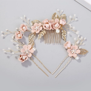 Elegant bridal hair accessory set with pink flowers, gold leaves and pearls on gray base
