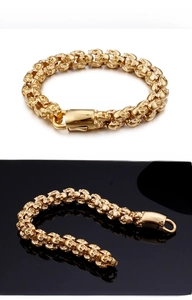 Detailed view of punk skull link bracelet with gold finish and polished clasp closure