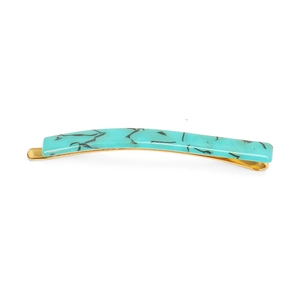 Detail of light blue marble acetate hair clip with golden metal spring fastener