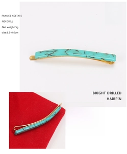 Detail showing marble texture acetate hairpin with gold metal clip, size 6.3x0.6cm