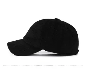 Detail of black plush baseball cap featuring a silver SPORT metal emblem on the side