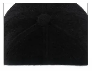 Macro view of tight top stitching on a black winter plush baseball cap with faux fur texture