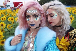 Close-up of colorful facial jewel stickers and glitter makeup for festival look