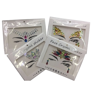 Detailed view of four colorful crystal face stickers in white card packaging