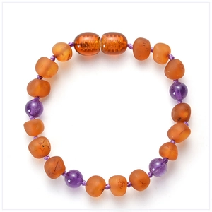 Detail of handcrafted Baltic amber baby bracelet with purple amethyst beads and safety clasp