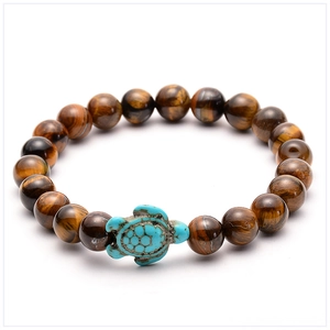 Close-up of tiger eye beaded bracelet with a blue sea turtle charm on white background