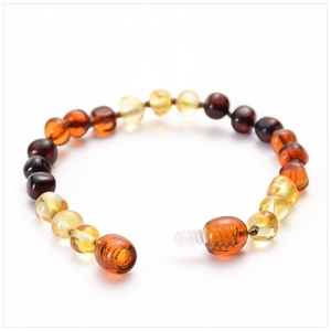 Macro detail of multicolored Baltic amber beads with a secure clear screw clasp