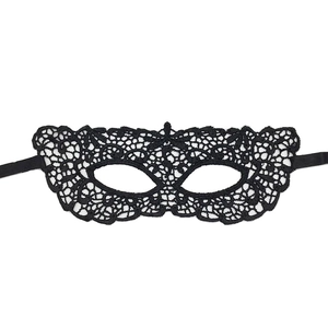 Close-up of black lace masquerade eye mask with hollow design and side ribbon ties