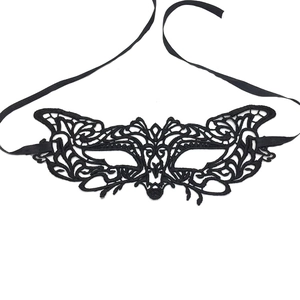 Detailed view of black lace masquerade eye mask with butterfly pattern and ribbon ties