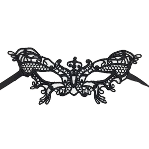 Close-up of black lace masquerade mask with intricate hollow butterfly wing pattern detail
