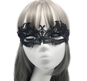 Detailed close-up of an elegant black lace masquerade eye mask worn by a model