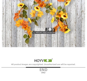 Detail of faux autumn garland featuring yellow sunflowers and orange maple leaves
