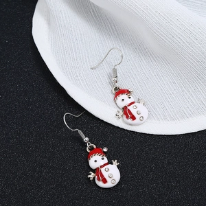 Close-up of snowman drop earrings with red hats and sparkling rhinestone accents