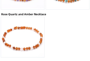 Detail view of baby necklace with orange amber and pink quartz crystal beads