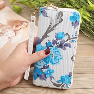 Detail of floral women wallet with blue flower print and detachable wristlet strap