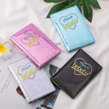 Detail of glitter passport covers in pink, blue, silver and black with heart pattern