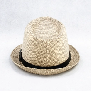 Detailed macro view of the natural beige linen texture and black decorative ribbon on fedora hat