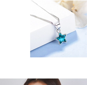 Close-up of blue star crystal pendant on a silver-tone necklace with polished finish