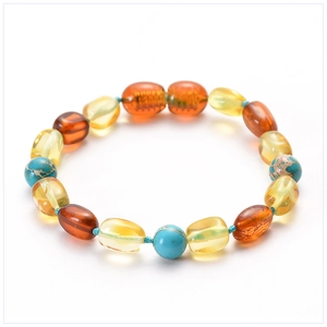 Detailed close-up of a Baltic amber baby bracelet with turquoise and cognac amber beads