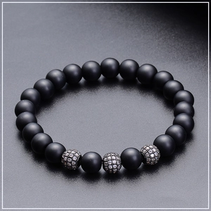 Macro shot of 8mm matte black stone beads bracelet with zircon-encrusted silver accents