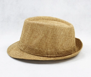 Close-up of a classic caramel straw fedora hat featuring a woven texture and matching band