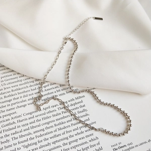 Detail of 925 sterling silver asymmetrical choker with bead and long link chain design