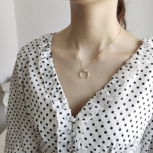 Detailed view of gold plated 925 silver crescent moon necklace with tiny zircons