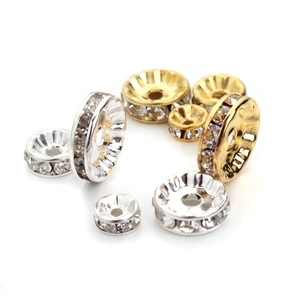 Macro shot of silver and gold plated rondelle spacer beads with crystals for DIY jewelry