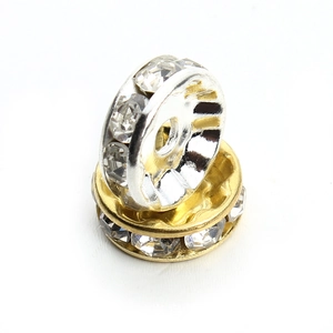 Macro shot of gold and silver plated spacer beads with clear crystal rhinestones