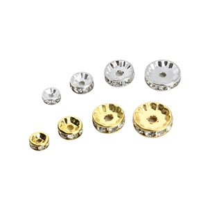 Macro detail of gold and silver rhinestone spacer beads in four assorted sizes for DIY jewelry