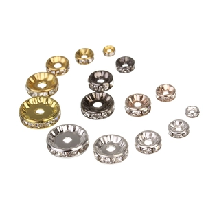 Macro shot of assorted rondelle spacers in gold, silver and rose gold for DIY jewelry