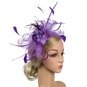 Elegant purple feather fascinator with mesh veil and flower detail for bridal hair styling