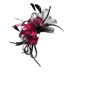 Detail of elegant black mesh fascinator with magenta feathers on a headband base