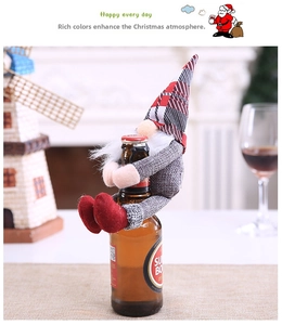 Close-up of red and white plaid gnome wine bottle topper decoration for holiday tables