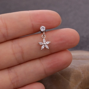 Macro view of flower-shaped pendant piercing jewelry with marquise-cut cubic zirconia
