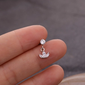 Detailed close-up of a silver crown piercing stud featuring sparkling clear zircon stones