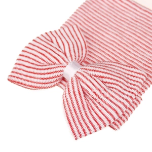 Close-up of red and white striped knit baby hat featuring a large soft bow detail