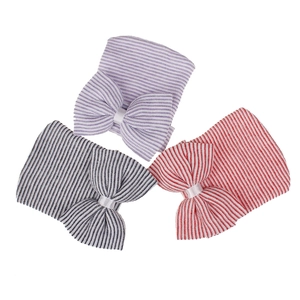 Three-pack of knitted newborn hats with striped patterns and large bow details